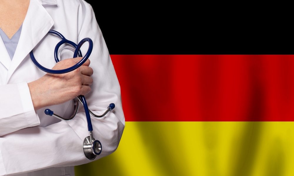 German,Medicine,And,Healthcare,Concept.,Doctor,Close,Up,Against,Flag